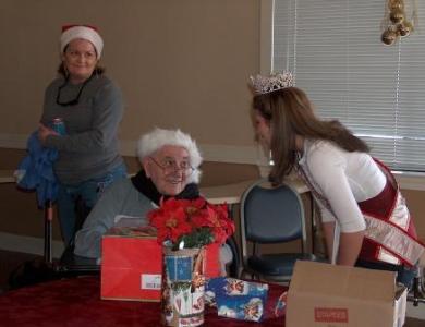 Ashley greeting a cheery Santa look-a-like resident